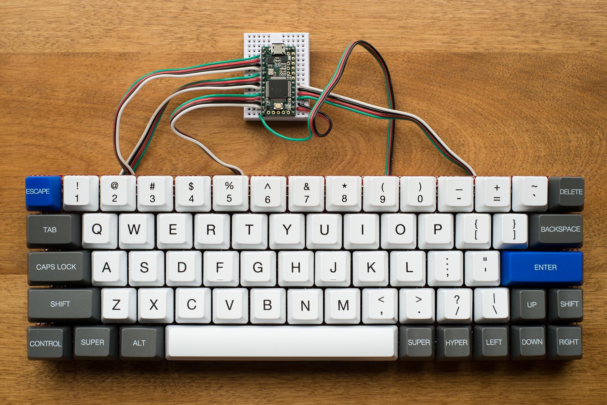 Top view of keyboard with switches soldered on and roughly wired to microcontroller