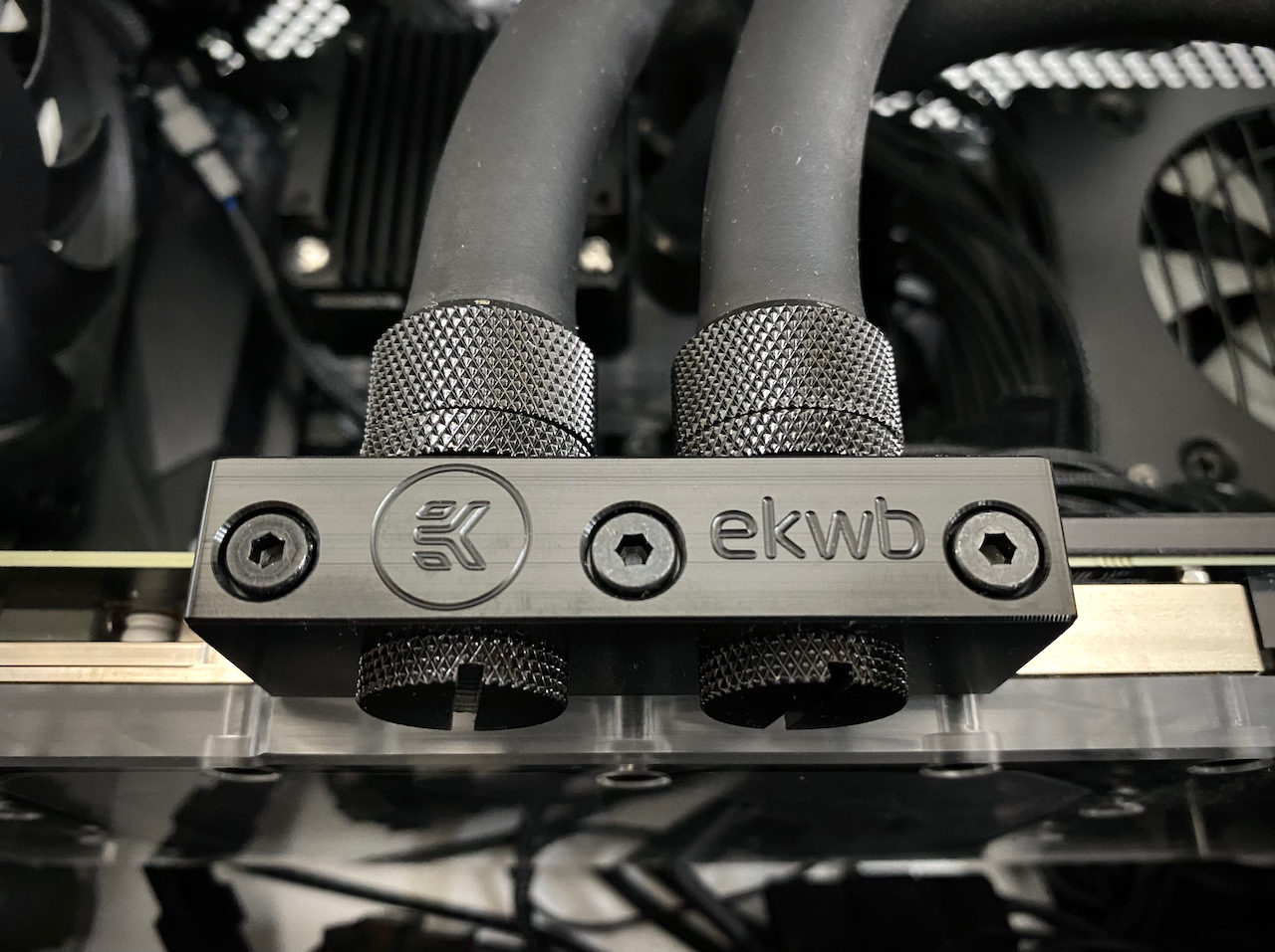 Close up picture of the black terminal block connected to the graphics card water block.